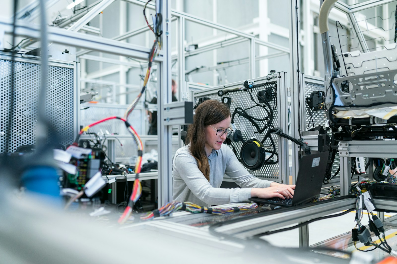 manufacturing, woman in white long sleeve shirt using black laptop computer